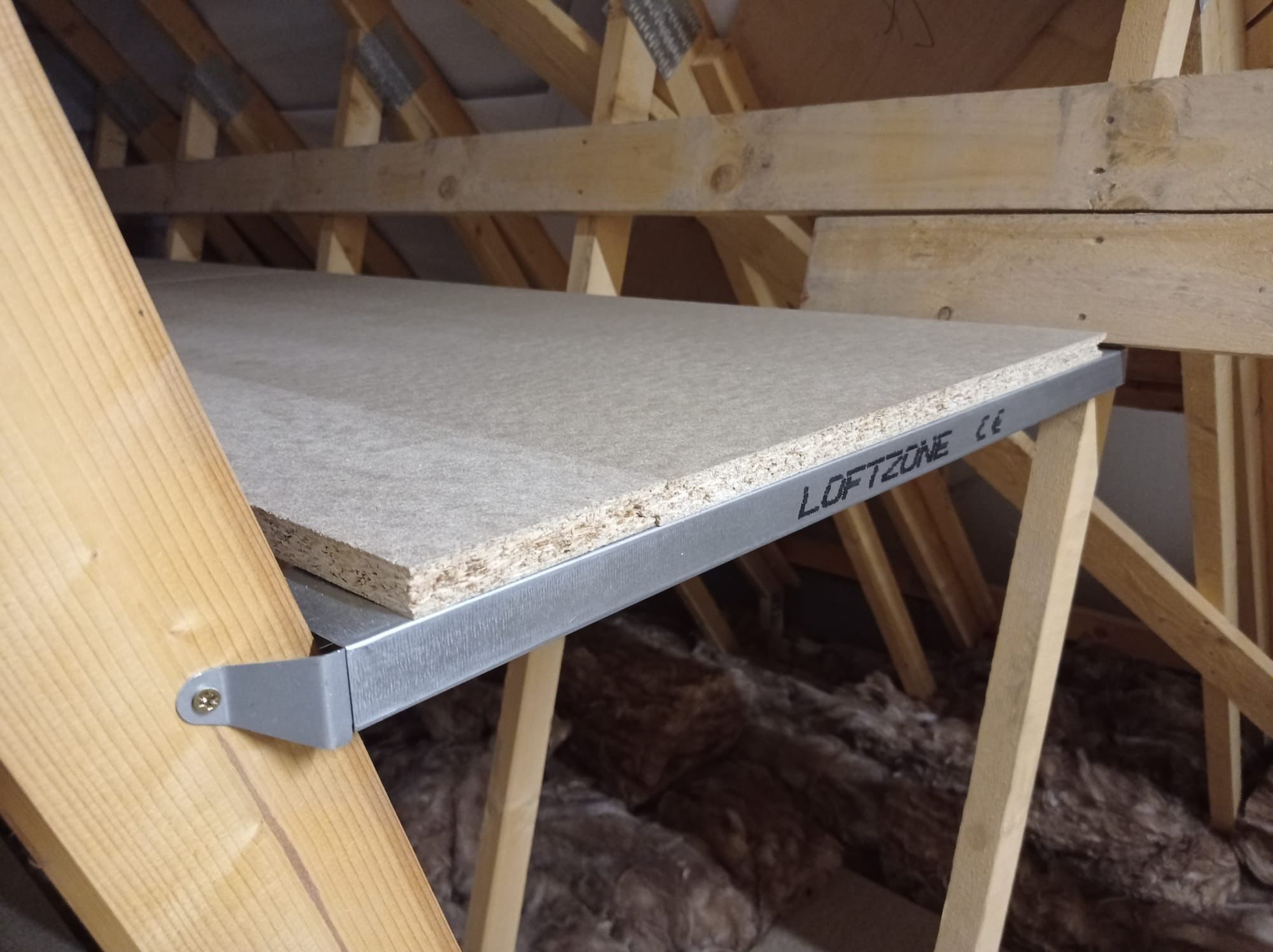 Loft Shelving Solutions: Our Steel TrussShelf 72 A loft shelf that has been attached between trusses with metal brackets.
