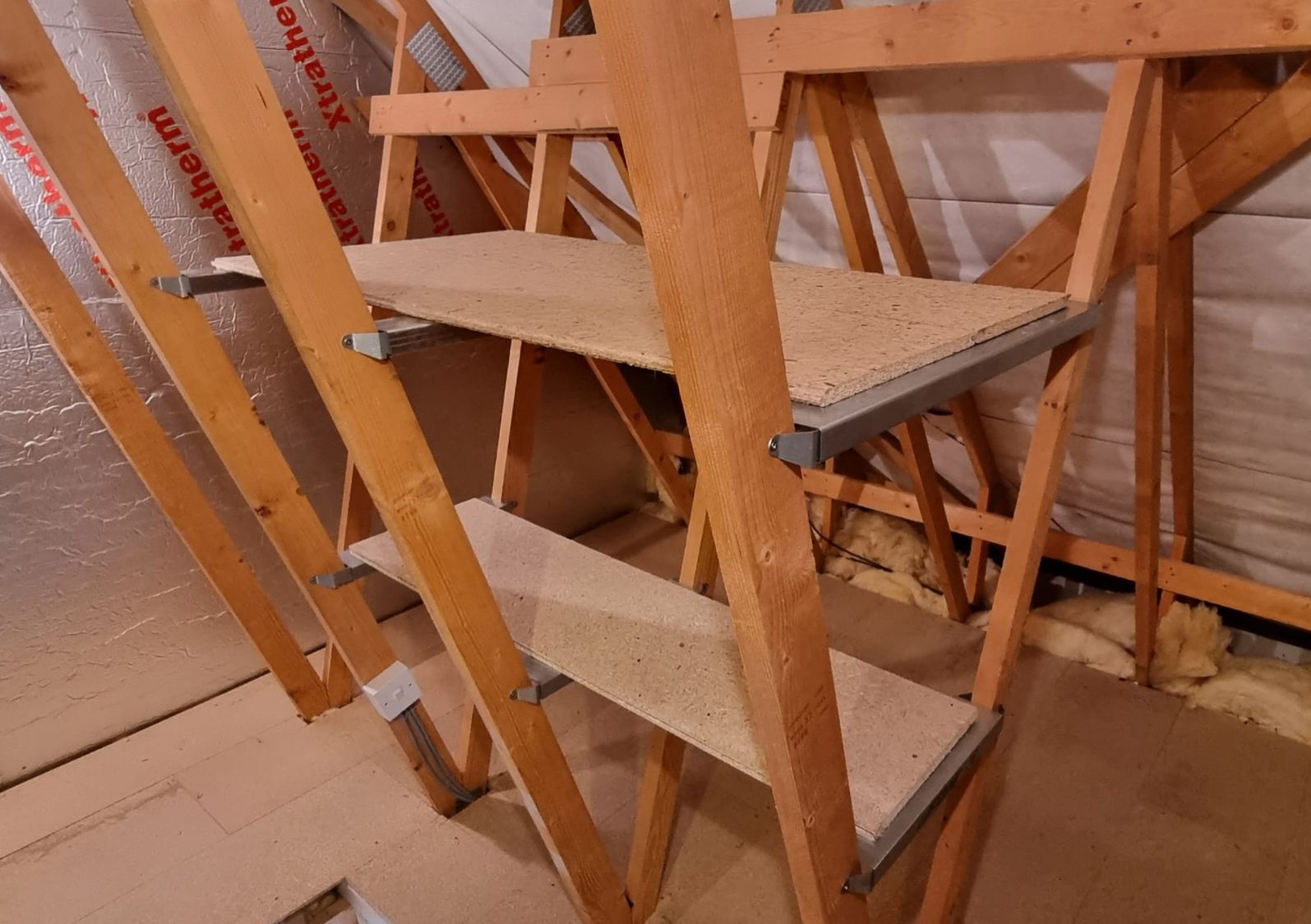 stacked loft shelving between the trusses