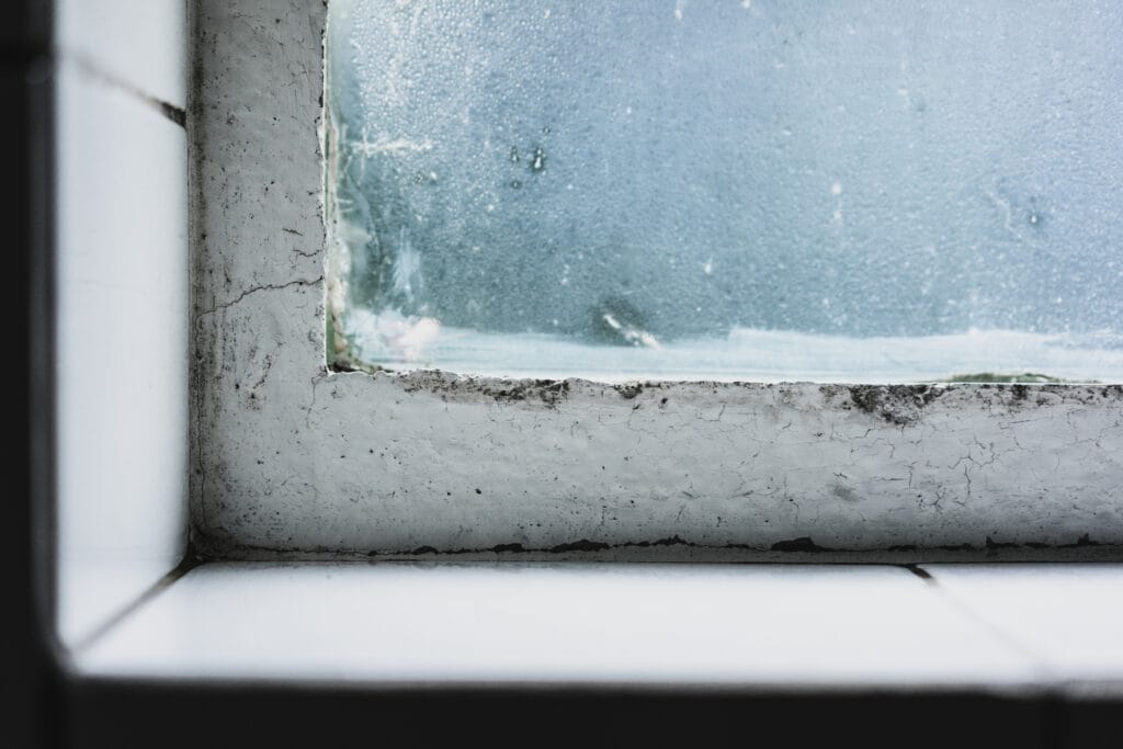 Blog 5 closeup shot wild windowsill with old window glass covered frosting
